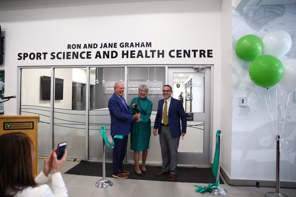 Dr. Chad London officially opens the Ron and Jane Graham Sports Science and Health Centre with Ron and Jane.